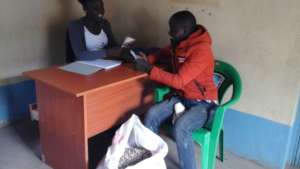 a farmer being paid for  his moringa seeds