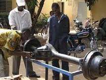 Fabiola learning Automotive repair skills in Haiti