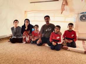 Dakheel and his family in their tent