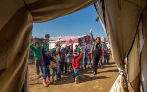 1) A teacher and her class during outside activity