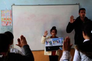 Zahraa reading the storybook in her class
