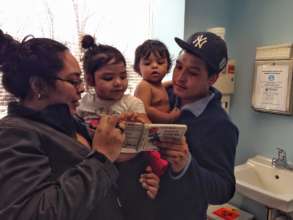 Ana, Roxi, Adrian, and Adrian Sr. read together