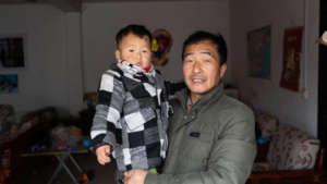 Kaikai and his grandfather share a moment.