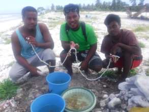 Making coral fragment leis for out-planting