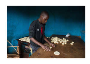 Bizimana rolling mandazi dough