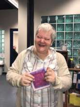 Joan having a great time learning cross-stitch.