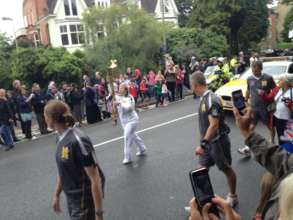 Maria carries the Olympic Torch