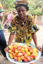 A woman shows the results of her gardening effort.