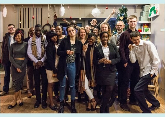 Guests and staff in front of the Christmas tree