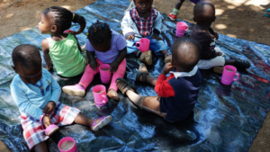 NIGEE beneficiaries' children enjoying Porridge