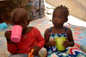 Kids enjoying a cup of 10'Oclock porridge at GEC