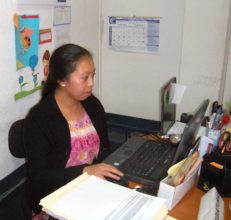 Mayra at work in an accounting office.