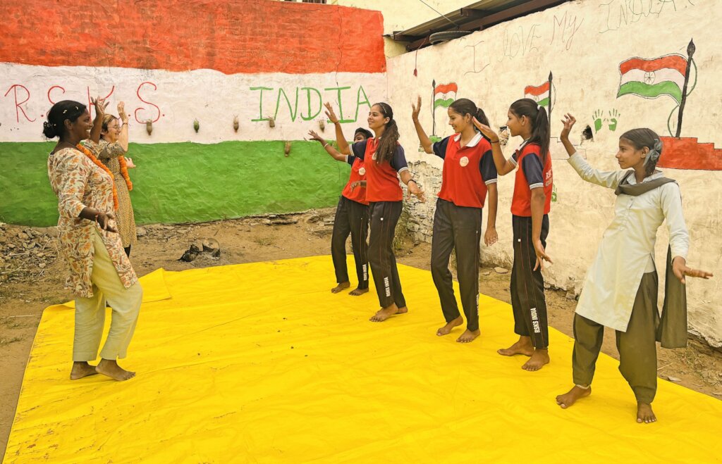 Visitors doing activities with beneficiary girls