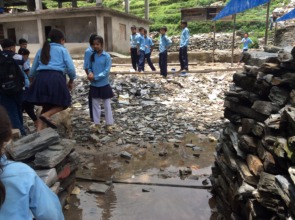 The kids play near rubble and damaged buildings
