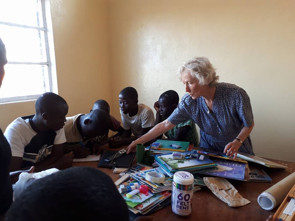 Marguerite teaching dominoes to the children
