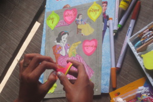 Sreyleap works on her art notebook