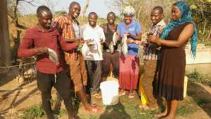 Some community members enjoying getting fresh fish