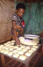 Consolata making mandazi (cakes)