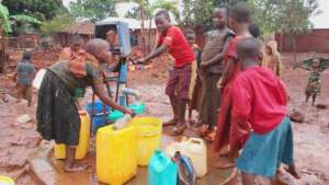 Julias collecting water for his family