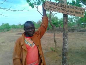 Vedasto with sign protecting the forest