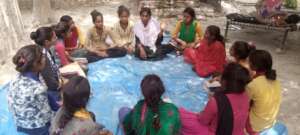 Anjali conducting a meeting in her community