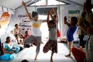 Women and girls doing yoga