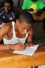Young man learning numeracy & literacy