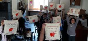 Happy Refugee children with their education kits