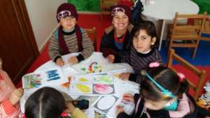 Syrian Refugee Children using the education kits