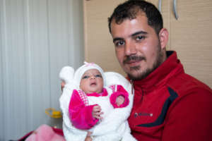 Odey and his new born daughter