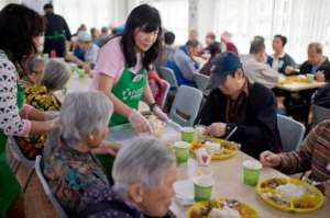 Volunteers serving elderly at the community centre