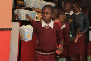 Kibera school girl with her soda/popcorn