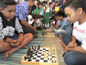 Students concentrating in chess competition