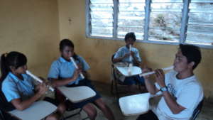 Primary school children practice recorder in music