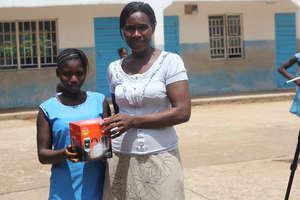 Girl with new solar light in Sierra Leone
