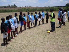 Coach Boniface instructing the girls during the training