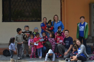 Volunteers and children at the Cuadras market