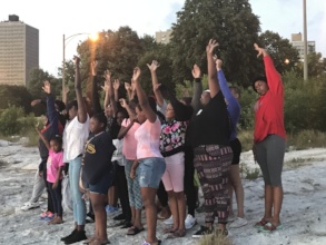 Girls practice mindfulness at sunrise