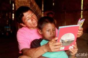 Matses father and son with reader