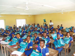 Students receiving mosquito bed nets