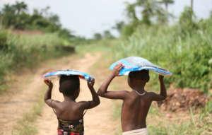 Carrying their mosquito bed nets home