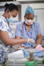 NICU Nurses treating a new-born