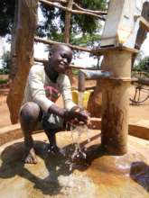 An excited resident of Angayiki B with clean water