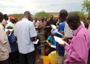 Mechanics assess a well in Apac, Uganda