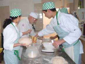 Youngsters learning how to mould bread