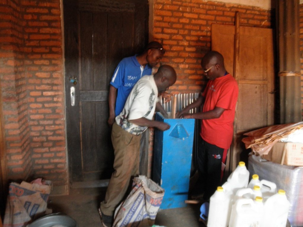 Educators building a water filter system a school