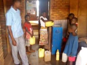 School children adding water to the filter system