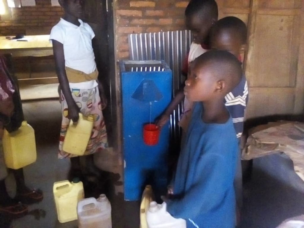 School children filling containers of clean water