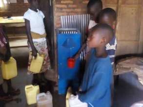 School children filling containers of clean water