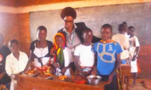Youth presenting food prepared from gardens
